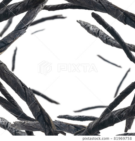 Dry twisted leaves of Kuding tea levitate on a white background 81969758