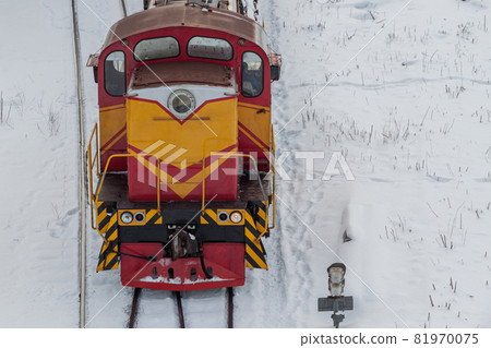 Diesel shunting locomotive at a snow-covered railway station. The concept of railway transportation Diesel shunting locomotive at a snow-covered railway station. The concept of railway transportation 81970075