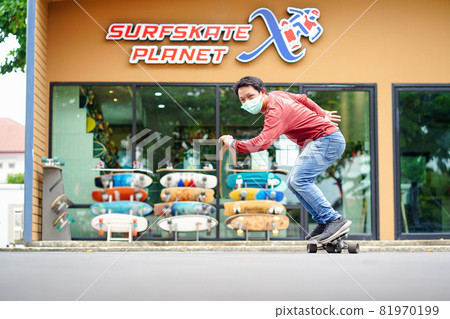 Asian Cheerful man playing surfskate or skate board in fron turn action over the surfskate planet x store sop at bangkok, Thailand .extream sport, healthy and exercise,fashion in covid19 concept Asian Cheerful man playing surfskate or skate board in fron turn action over the surfskate planet x store sop at bangkok, Thailand .extream sport, healthy and exercise,fashion in covid19 concept 81970199
