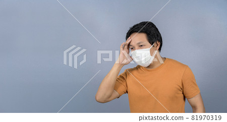 Asian man wearing face surgical mask Headache and worry on blue background, Coronavirus pandemic, covid19 outbreak, social distancing and responsibility,healthcare and protection against virus concept Asian man wearing face surgical mask Headache and worry on blue background, Coronavirus pandemic, covid19 outbreak, social distancing and responsibility,healthcare and protection against virus concept 81970319