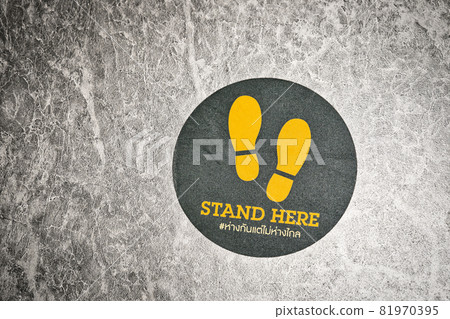 Stand here Text with thai language with the same meaning on the floor in department store Stand here Text with thai language with the same meaning on the floor in department store 81970395