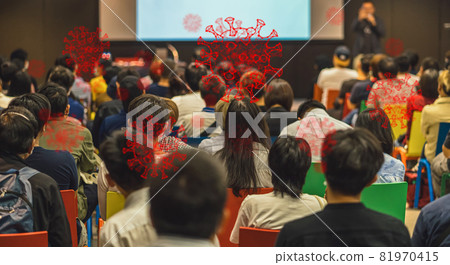 Coronavirus Network Outbreak over Rear view of Audience listening Speakers on the stage in the conference hall or seminar meeting, business and education take risk for covid19, social distance concept 81970415