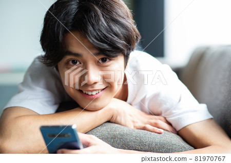 Young man lying on the couch Young man lying on the couch 81970767