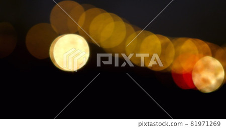 Digital image of glowing golden spots of light moving against against black background Digital image of glowing golden spots of light moving against against black background 81971269