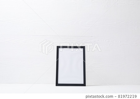 Composition of white card in black frame with copy space on white background 81972219