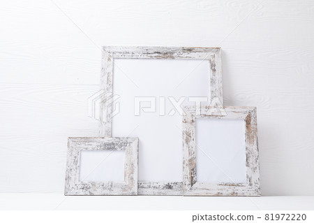 Composition of white cards in distressed white frames with copy space on white background 81972220