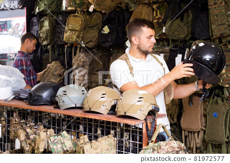 Men with helmet in hands standing 81972577