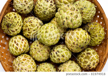 Custard apple in bamboo basket on white background. Custard apple in bamboo basket on white background. 81974918