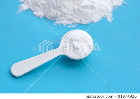 Baking soda on blue background. Baking soda on blue background. 81974920