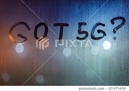 the question got 5G written by finger on wet glass with blurred lights in background 81975430