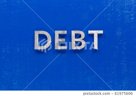the word debt layed on blue painted board with thick silver metal aphabet characters the word debt layed on blue painted board with thick silver metal aphabet characters 81975606