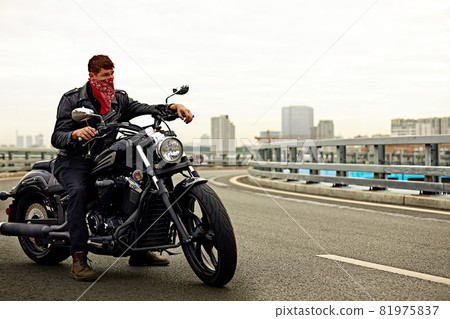 young man riding big bike ,motorcycle on city road against urban and town building scene young man riding big bike ,motorcycle on city road against urban and town building scene 81975837