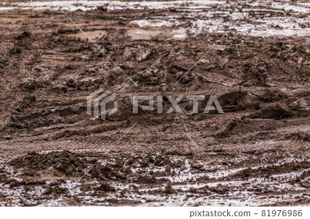 dirty mud road background at winter with selective focus and blur dirty mud road background at winter with selective focus and blur 81976986