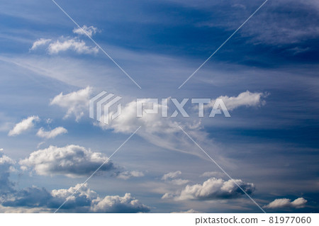 Regular spring clouds on blue sky at daylight in continental europe. Shot wit telephoto lens and polarizing filter. 81977060