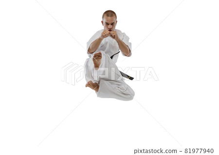 In a jump. Portrait of one caucasian sportsman training isolated over white background. Karate, judo, taekwondo sport 81977940