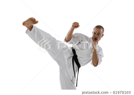 Cropped portrait of caucasian sportsman standing in side kick pose isolated over white background. Karate, judo, taekwondo sport Cropped portrait of caucasian sportsman standing in side kick pose isolated over white background. Karate, judo, taekwondo sport 81978103