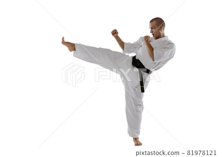Cropped portrait of caucasian sportsman standing in side kick pose isolated over white background. Karate, judo, taekwondo sport Cropped portrait of caucasian sportsman standing in side kick pose isolated over white background. Karate, judo, taekwondo sport 81978121