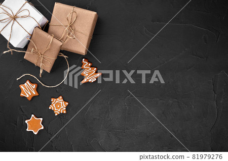 Christmas composition. Xmas cookies, gifts, festive decoration on black background. Flat lay, top view, with copy space. Christmas composition. Xmas cookies, gifts, festive decoration on black background. Flat lay, top view, with copy space. 81979276