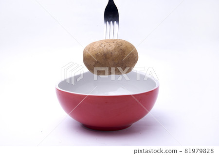 Fork with potato above the bowl Fork with potato above the bowl 81979828