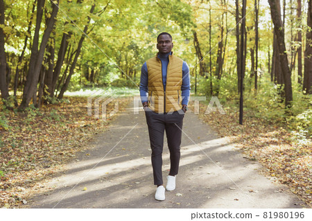 African american student walking in the park in autumn season African american student walking in the park in autumn season 81980196