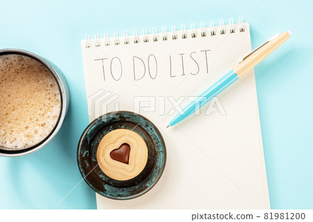 To do list. A paper notebook with a blue pen and a coffee mug, overhead flat lay To do list. A paper notebook with a blue pen and a coffee mug, overhead flat lay 81981200
