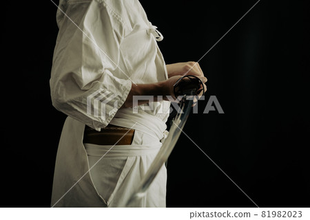 A person holding a Japanese sword A person holding a Japanese sword 81982023