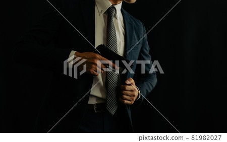 一個穿著西裝拿著手槍的人 81982027