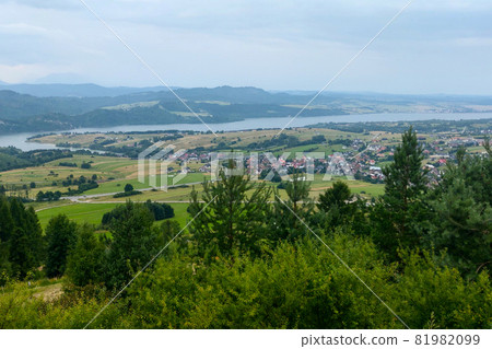 Beautiful scenic view from a height of the mountainous terrain on a cloudy autumn day. Beautiful scenic view from a height of the mountainous terrain on a cloudy autumn day. 81982099