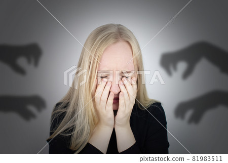 The woman is experiencing a panic attack. The concept of phobia, fears, paranoia and persecution mania. Shadow silhouettes surrounded the man. Nervous breakdown and nervous disorders The woman is experiencing a panic attack. The concept of phobia, fears, paranoia and persecution mania. Shadow silhouettes surrounded the man. Nervous breakdown and nervous disorders 81983511