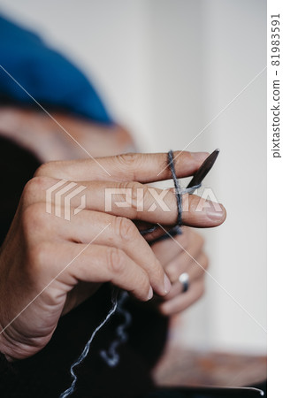 caucasian man knitting a piece 81983591