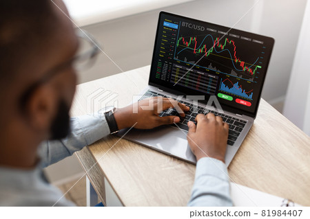 Black Businessman Using Laptop, Trading Online, High-Angle View Black Businessman Using Laptop, Trading Online, High-Angle View 81984407