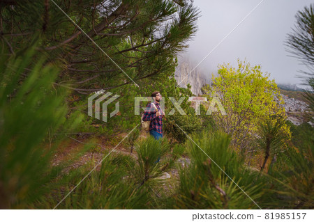 Travel man with backpack hiking in the mountains Travel man with backpack hiking in the mountains 81985157