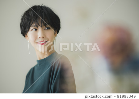 A woman in a dark green knit 81985349