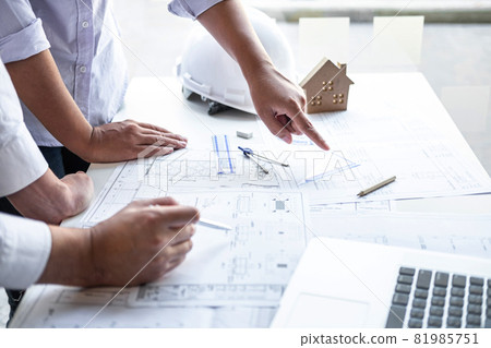 Team of engineering or architect meeting and discussing on blueprint and building model while checking information on sketching for architectural project 81985751