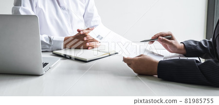 Employer or committee holding reading a resume with talking during about his profile of candidate, employer in suit is conducting a job interview, manager resource employment and recruitment concept Employer or committee holding reading a resume with talking during about his profile of candidate, employer in suit is conducting a job interview, manager resource employment and recruitment concept 81985755