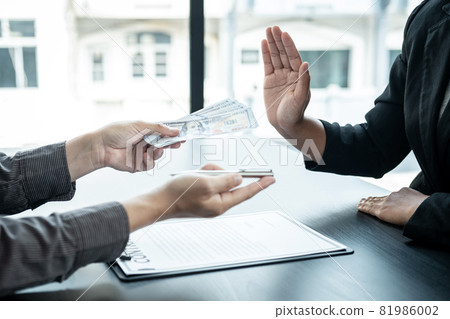 Close up of man employee offering bribe money and pen to businessman to signing the contract to joint engage Close up of man employee offering bribe money and pen to businessman to signing the contract to joint engage 81986002