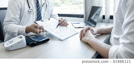Doctor consulting with the patient and checking sickness condition while presenting results diagnosis symptom examining about the problem of illness and recommend treatment method Doctor consulting with the patient and checking sickness condition while presenting results diagnosis symptom examining about the problem of illness and recommend treatment method 81986121