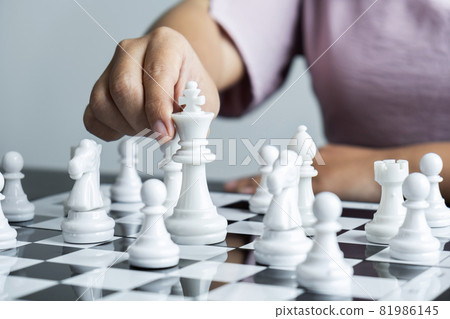 Woman playing chess and thinking strategy plan about crash overthrow the opposite team and development analyze for successful Woman playing chess and thinking strategy plan about crash overthrow the opposite team and development analyze for successful 81986145