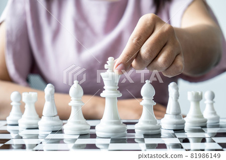 Woman playing chess and thinking strategy plan about crash overthrow the opposite team and development analyze for successful Woman playing chess and thinking strategy plan about crash overthrow the opposite team and development analyze for successful 81986149