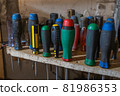 Set of different scredrivers on a shelf. 81986353