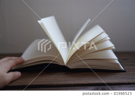 Open book on a table 81986523