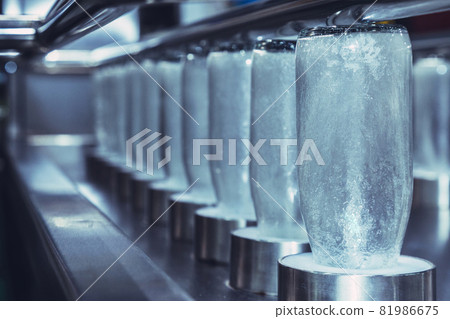 clear glass bottles for medicine, food and beverage product are in process of cleaning for hygienic by hot water in the automatic glass bottle washing machine at the manufacturing. innovation 81986675