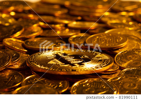 Gold cryptocurrency Bitcoin against the background of many other gold coins in hard light. New concept of the rising value of based blockchain industry digital cryptocurrencies. Close Up. 81990111