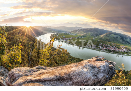 Panorama of Wachau valley (Unesco world heritage site) with Danube river at colorful sunset against Duernstein village in Lower Austria, Austria 81990409
