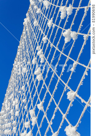 Volleyball net covered with snow. Nature's minimalism.  81990698