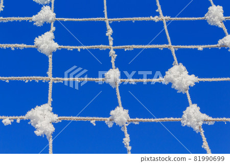 Volleyball net covered with snow. Nature's minimalism.  81990699