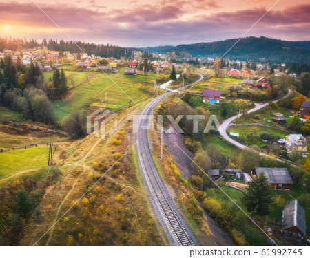 Beautiful old railway station and village at sunset in mountains Beautiful old railway station and village at sunset in mountains 81992745