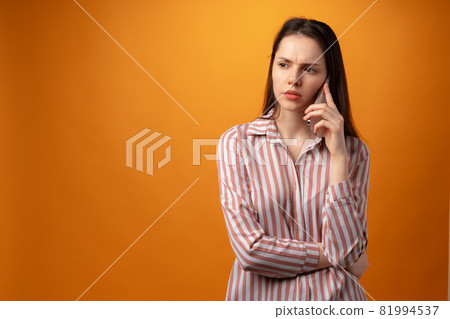 Stressed frustrated young woman holding smartphone, recieved bad news, yellow background 81994537
