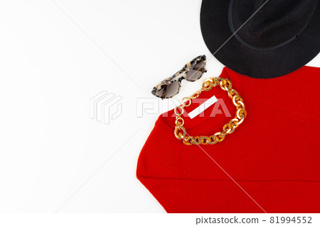 Woman outfit with red sweater and accessories on white 81994552