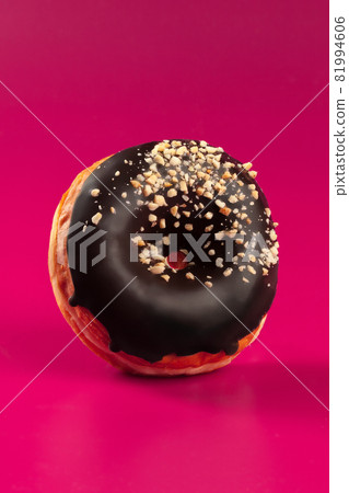 Yummy glazed round donut on a bright pink background 81994606